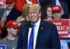 Taxpayer Ad Sparks Trump Propaganda Brawl Donald Trump at a rally speaking at a microphone