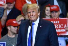 Taxpayer Ad Sparks Trump Propaganda Brawl Donald Trump at a rally speaking at a microphone