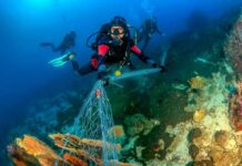 Air Force Wanted Fishermen’s Haul Scuba diver removing fishing net from coral reef