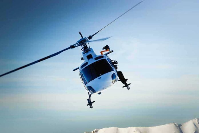 shutterstock_116155468 helicopter banking over snowy mountains