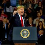 Trump’s Endorsements: Powerhouse or Pitfall? Donald Trump speaking at a rally behind a presidential podium