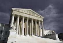 United States Supreme Court building with columns under stormy sky