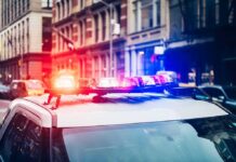 ATM Heist Turns Into Money Blizzard Police car with flashing lights in city street