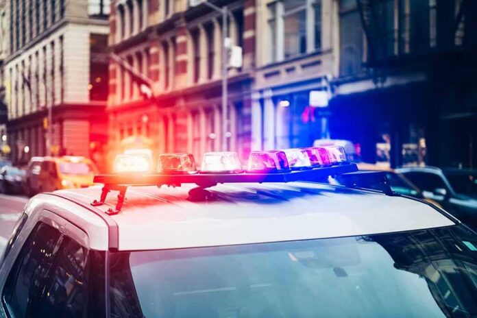 Police car with flashing lights in city street