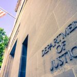 Department of Justice building facade with American flag