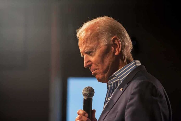shutterstock_1390542533 Joe Biden speaking into a handheld microphone on stage