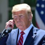Cheating Claims, Zero Scorecards man in suit at podium adjusting earpiece