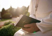 Vatican Throws Down: Dignity Or Disorder Person in white robe holding a Bible outdoors