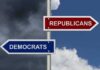 Directional signs for two political parties on a pole