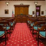 Courtroom with wooden benches facing the judge's bench