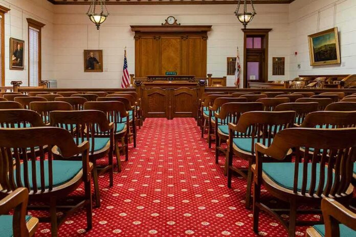Courtroom with wooden benches facing the judge's bench
