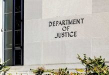 A Notorious Spider Just Landed In America’s Web Department of Justice building exterior wall