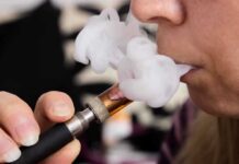 America’s Nicotine Rules May Be Getting Rewired Close-up of a person vaping, exhaling smoke clouds