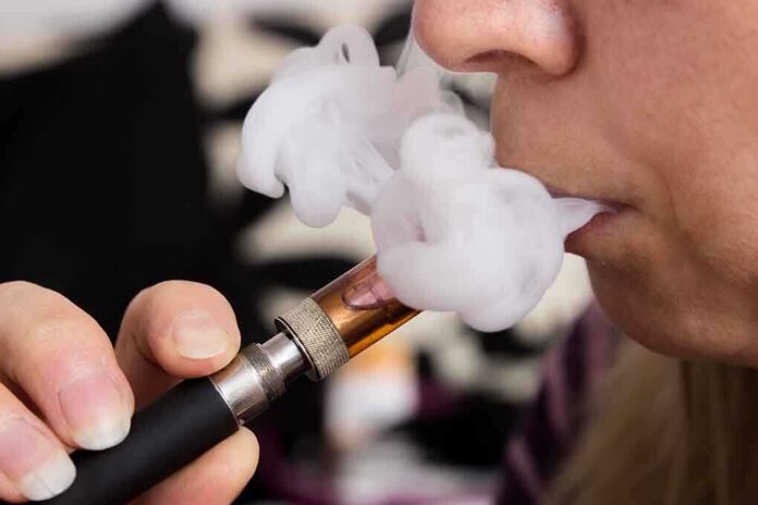 shutterstock_166583426-2 Close-up of a person vaping, exhaling smoke clouds