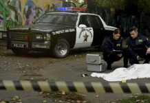 Targeted Lot Shooting – In-Laws Jailed Crime scene with police car and two investigators by a covered body
