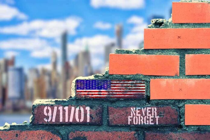 shutterstock_2022368618 Brick wall with American flag and memorial text against city skyline