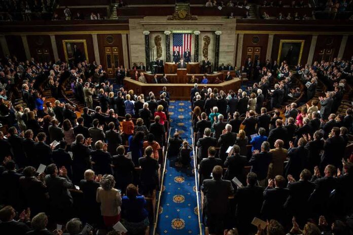 shutterstock_218485888-1 Legislative chamber audience stands and applauds