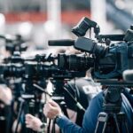Video Leak Shakes Up California Race Broadcast cameras on tripods at a press event