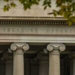 Neoclassical building facade with Ionic columns and engraved frieze