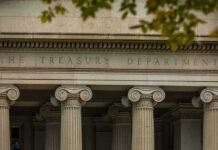Neoclassical building facade with Ionic columns and engraved frieze