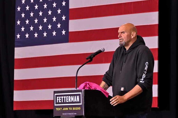 man at podium speaking with US flag backdrop