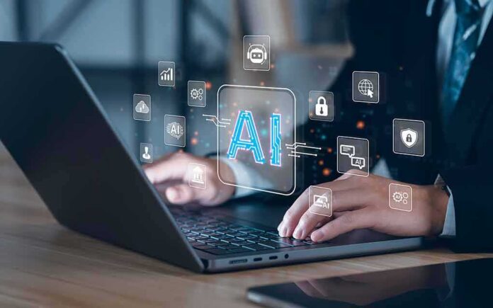 shutterstock_2284088327 Hands typing on laptop with AI and tech icons overlay