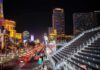 Las Vegas Strip at night with traffic and grandstand seating
