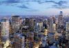 City skyline at dusk with illuminated skyscrapers