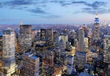 City skyline at dusk with illuminated skyscrapers