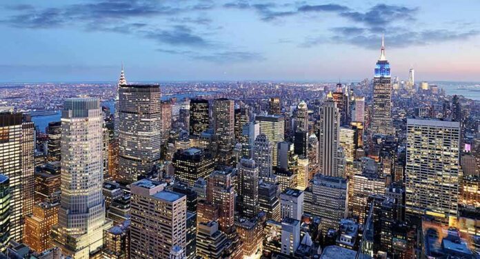 shutterstock_421599910 City skyline at dusk with illuminated skyscrapers