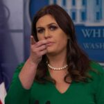 A Magic Trick Became Political Theater Woman at press briefing pointing toward audience