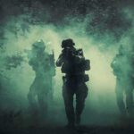 Trump Teases Iran Strike Countdown Soldiers move through dense smoke in a forest