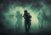 Trump Teases Iran Strike Countdown Soldiers move through dense smoke in a forest