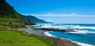 Rocky coastline with blue ocean and grassy cliffs