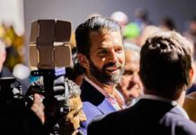 Donald Trump Jr. smiling in a crowd at an event