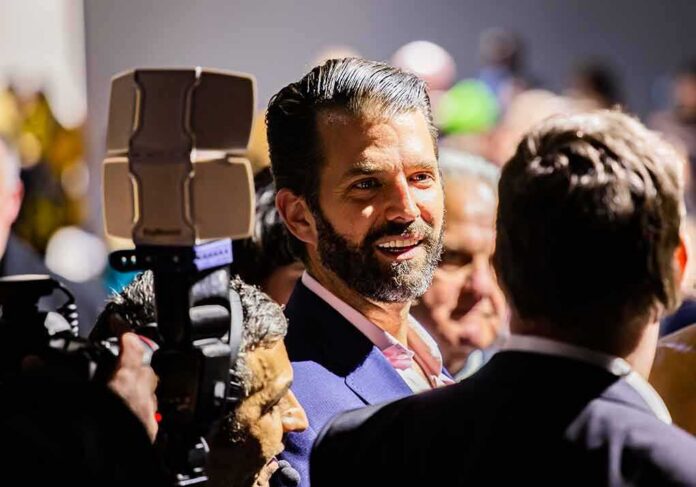shutterstock_1314219836 Donald Trump Jr. smiling in a crowd at an event