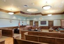 Judge Slams School: Apologize, Pay Up Empty courtroom with wooden benches and judge's bench