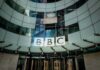 Screens Blaze, BBC Says Peaceful BBC headquarters entrance with curved glass facade