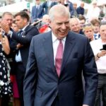 Prince Andrew, Duke of York smiling in a crowd at an outdoor event