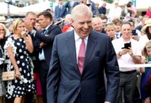 Prince Andrew, Duke of York smiling in a crowd at an outdoor event