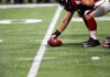 football player setting the ball on the line of scrimmage