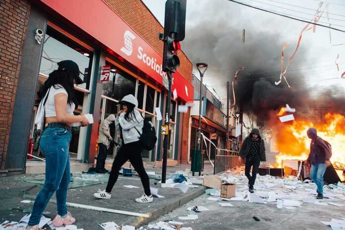 Street protest with fire and smoke outside a bank
