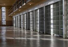 Execution Chaos: Inmate Reportedly Still Breathing Row of prison cells with metal bars along an empty corridor