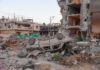 Drone Strike Mystery: Militants Or Civilians? Overturned car amid rubble and heavily damaged buildings