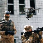 Marines Unleash Explosive Drones In Japan Quadcopter drone flying above soldiers in camouflage