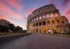 Colosseum exterior at sunset with glowing arches