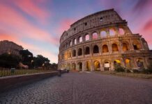 Colosseum exterior at sunset with glowing arches