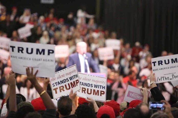 supporters hold signs at a political rally