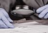 Parents’ Hit-And-Run Lie Unravels Gloved hands examine bullet casing with magnifying glass
