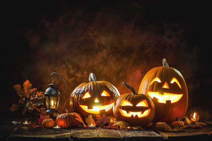 Jack-o'-lantern pumpkins glowing on a rustic table
